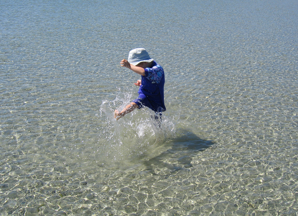 Child splashing at Tribune Bay beach