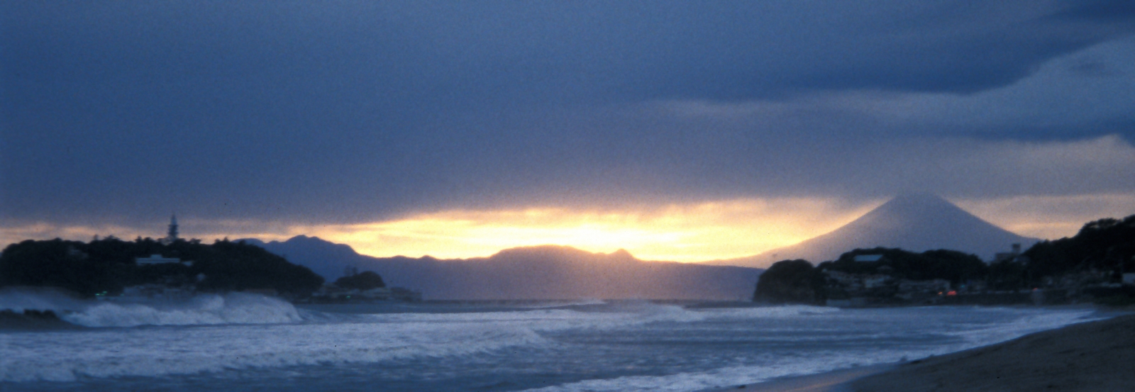 Mount Fuji behind the clouds on Kamakura beach