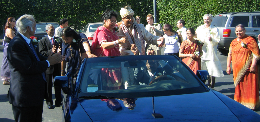 Groom’s parade in the parking lot at Rohit and Smruti’s wedding