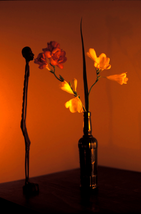 African figurine, flower arrangement