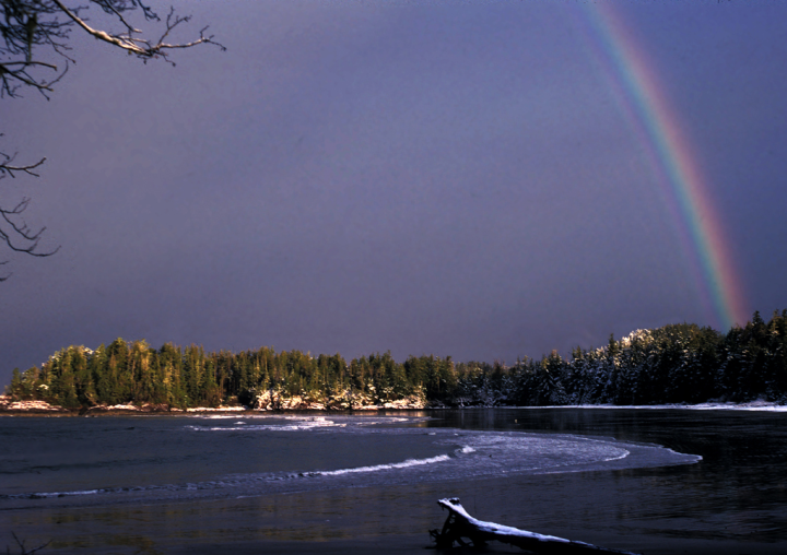 Sunlight, snow and rainbow on the beach