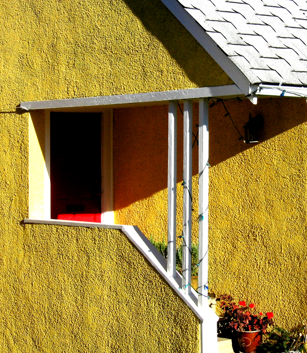 Yellow stucco house in slanting sun