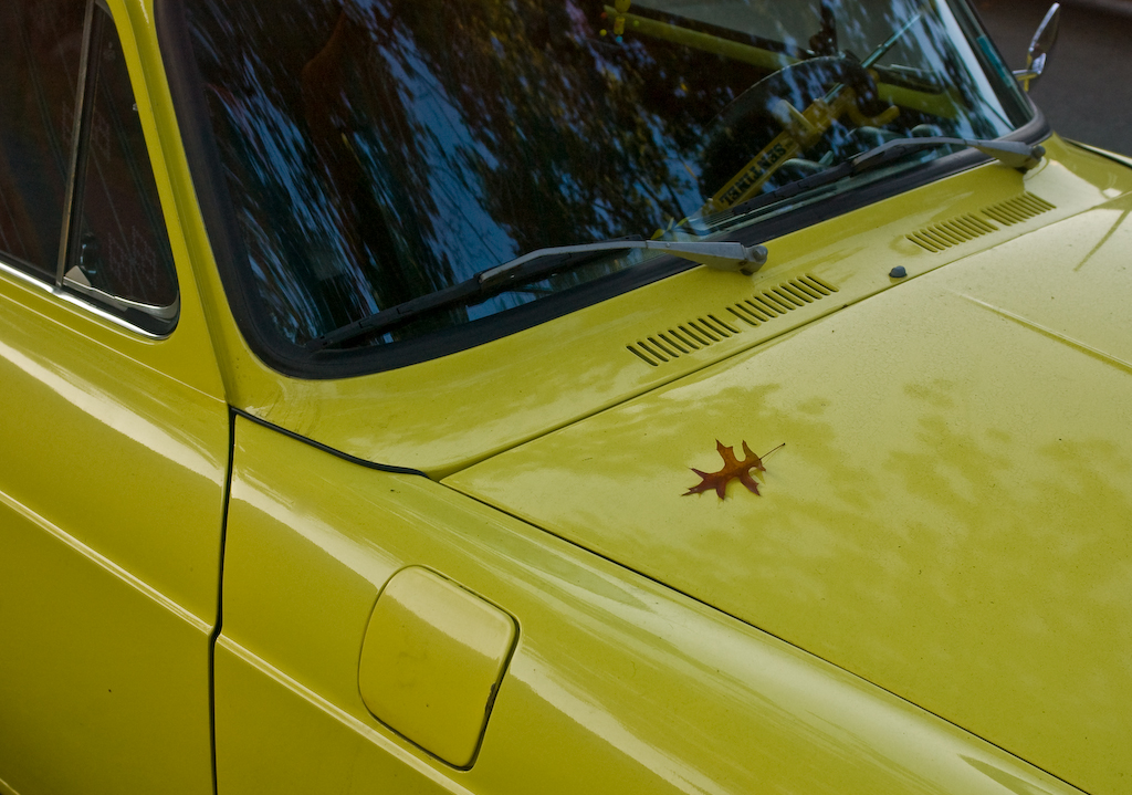 Autumn leaf on seventies yellow Volkswagen