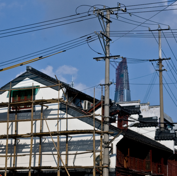 Tower under construction behind house under construction in the Yuyuan area of Shanghai