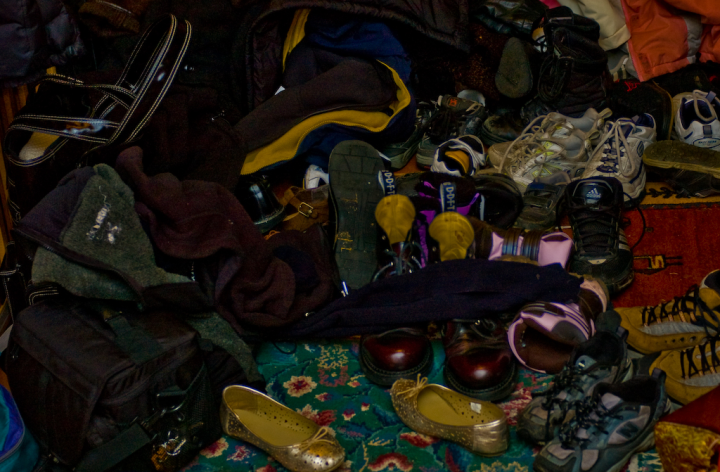 Assembled shoes and other paraphernalia in the front hall during party