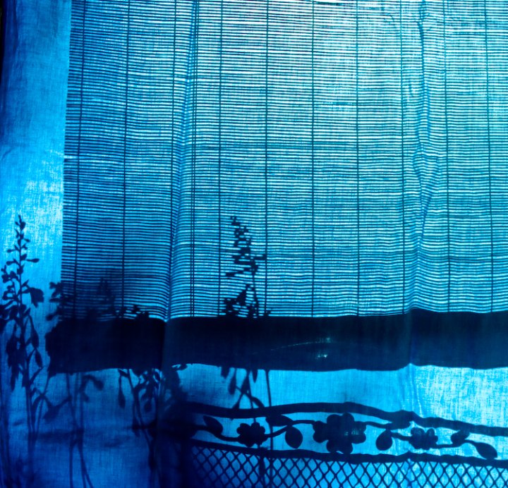 Porch shadows on blue bedsheet