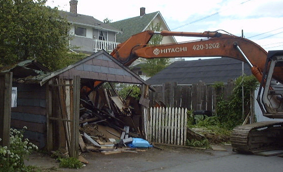 Tumbledown garage being destroyed