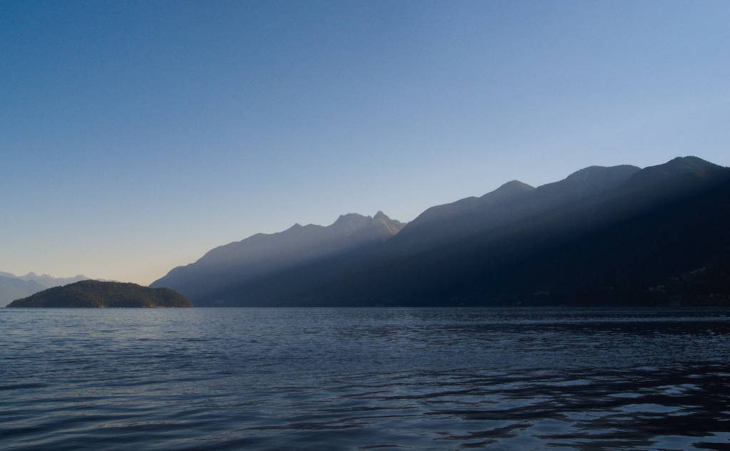 Sunshine spilling over mountains onto Howe Sound