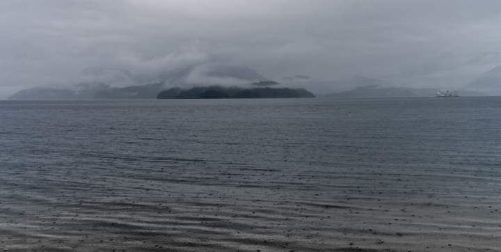 Distant ferry and Gambier Island in the rain