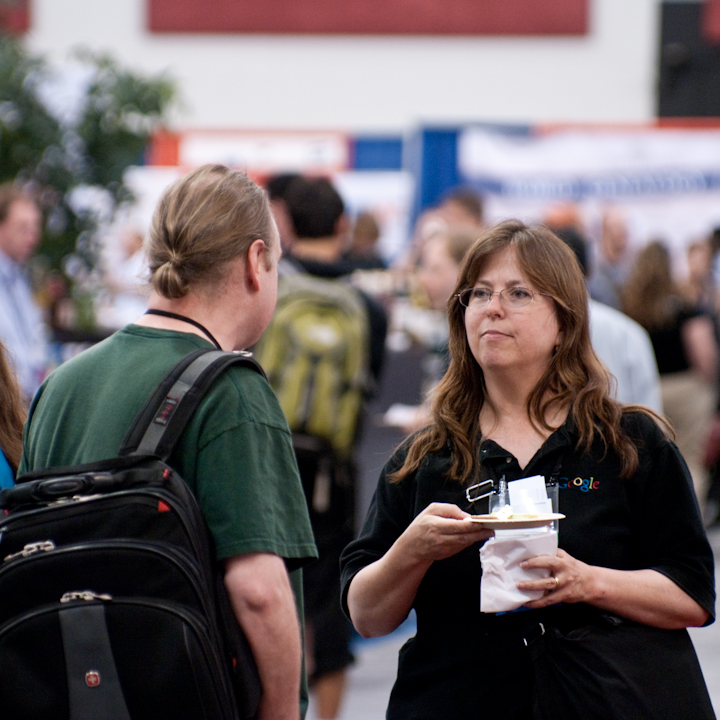 Brian Behlendor talks to someone in a Google T-shirt