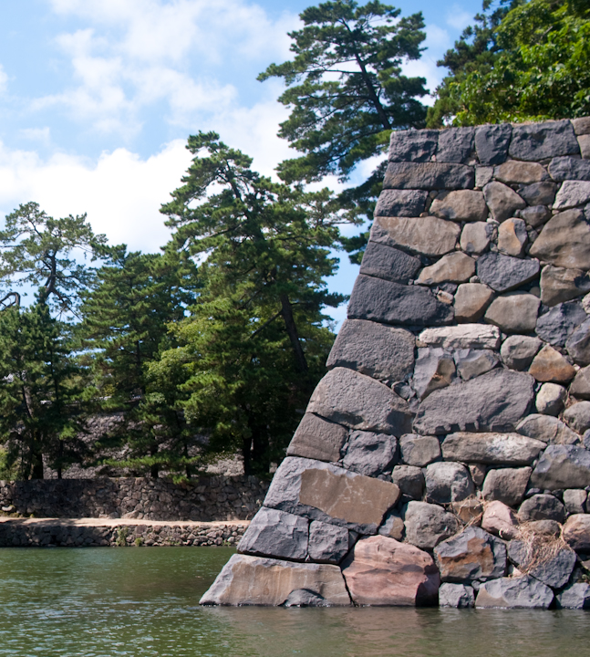 The corner of Matsue castle’s outer wall bathed in the water of its moat