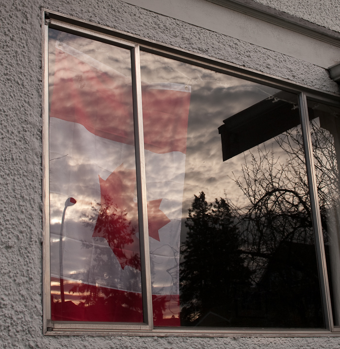 Canadian flag on display in a window