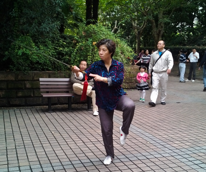Lady practicing Tai Chi with a sword in People’s Park, Shanghai