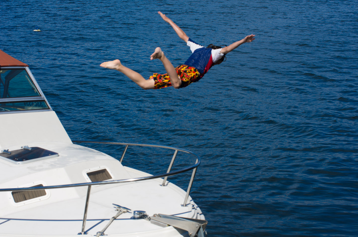 Boy leaps off boat