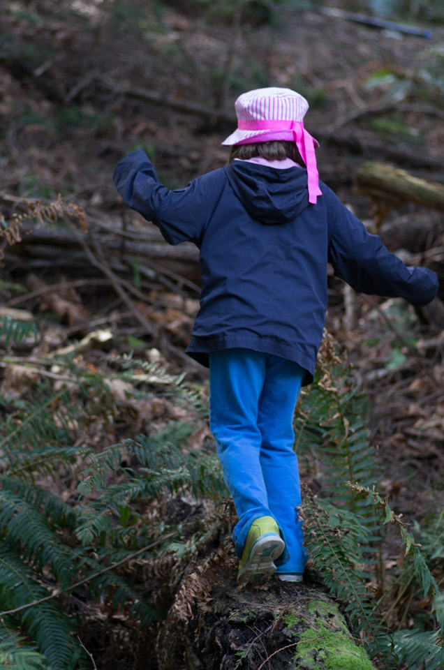 Girl walks on mossy log on Keats Island