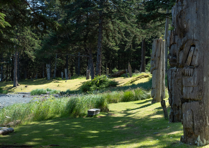 Standing totems at the SG̱ang Gwaay village site in Gwaii Haaans