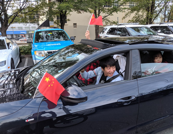 Pro-Beijing demonstrators in expensive cars