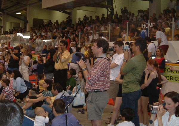 Audience filming gymnastics recital