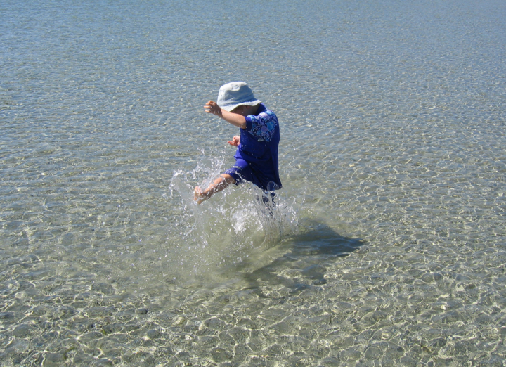 Child splashing at Tribune Bay beach