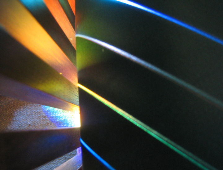 Rainbows on wood and leather chair - close-up