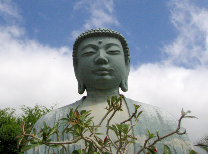 Image of Buddha in the Lahaina Buddhist mission, with helicoper 