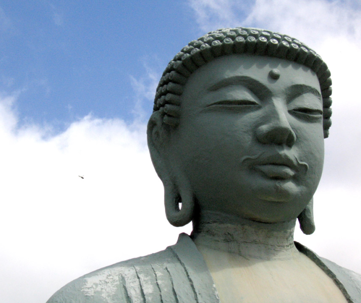 Image of Buddha in the Lahaina Buddhist mission, with helicoper 