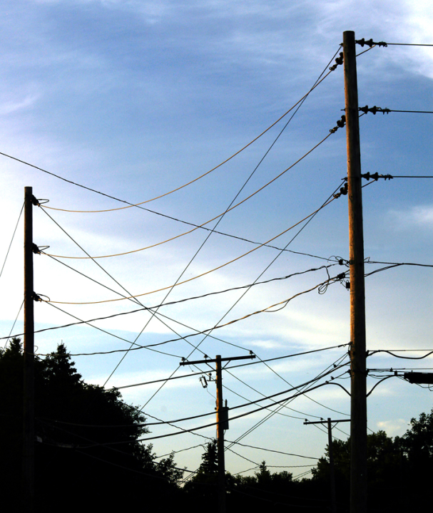Pattern of electrical wires against prairie sky