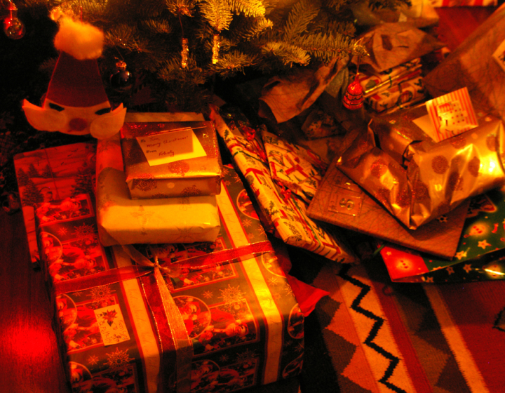 Firelit presents under the tree.