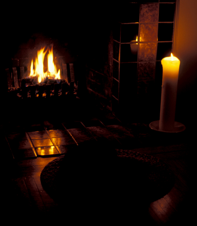 Domestic bliss; fireplace, candle, cat