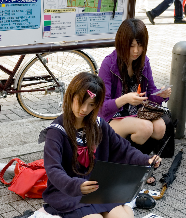 Young women posing for the camera in Akihabara Young women posing for the camera in Akihabara