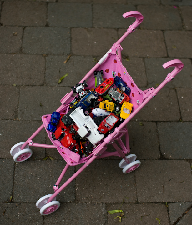 Stroller full of toy cars and trucks