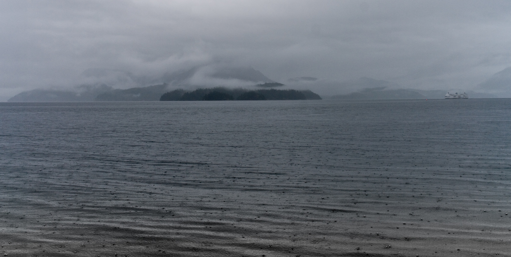 Distant ferry and Gambier Island in the rain