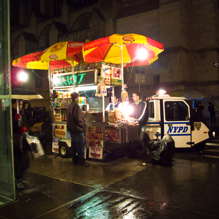 Food stand in Manhattan in the dark in the rain