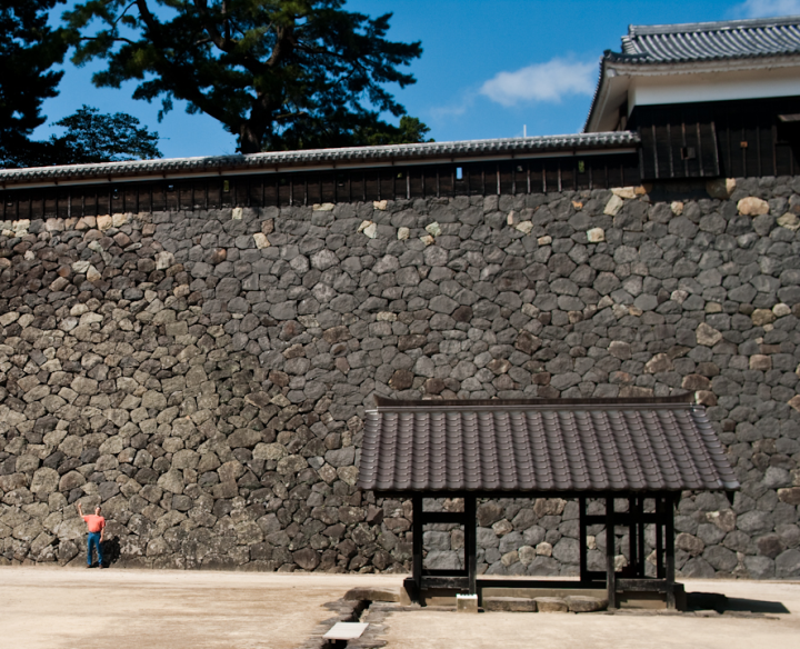 Bruce Tate stands in front of Matsue castle wall