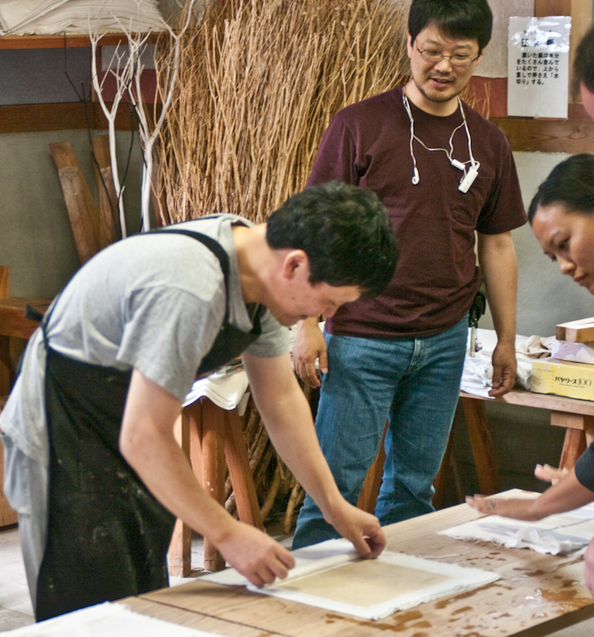 Abe-san of Abe museum instructing tourists on the making of washi paper at the Abe memorial museum in Yakumo, Shimane
