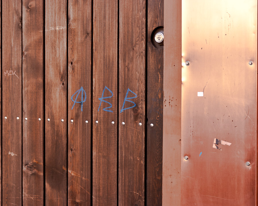 Copper, wood and graffiti on The Drive in Vancouver