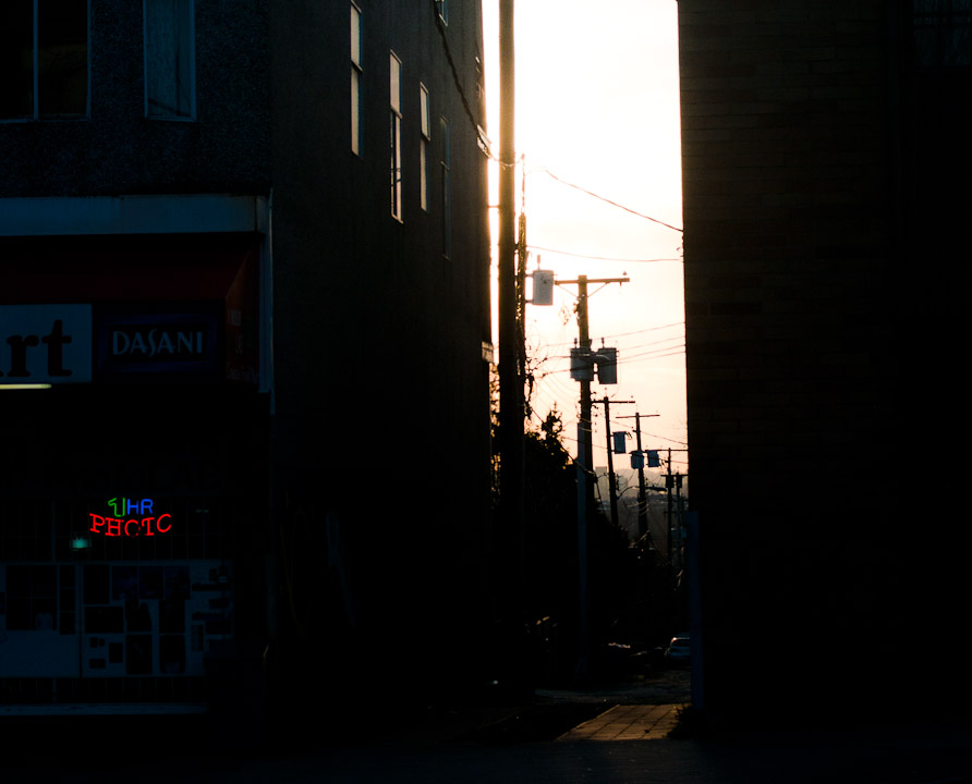 Looking west at sunset down an alley off The Drive in Vancouver