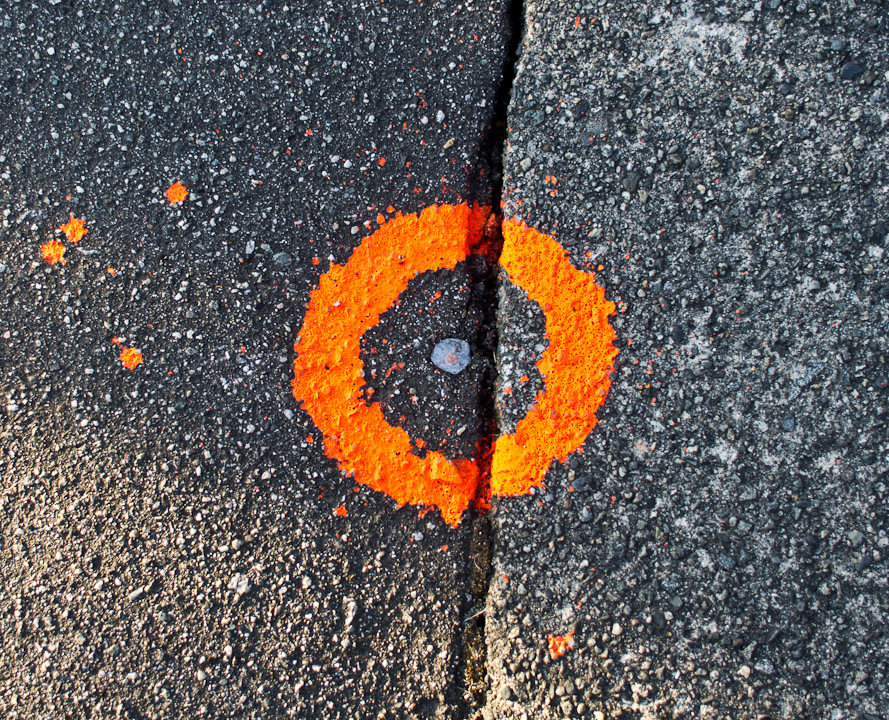 Orange circle around pavement nail
