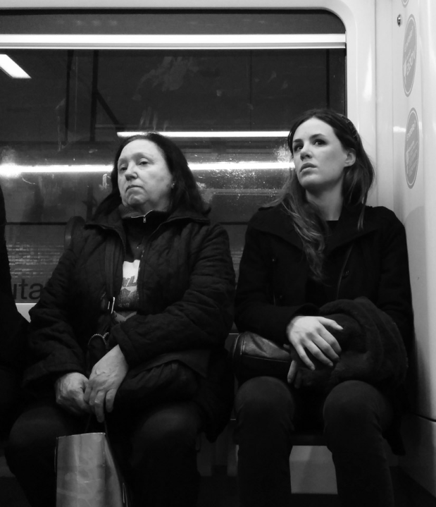 Two women on Barcelona subway in black and white