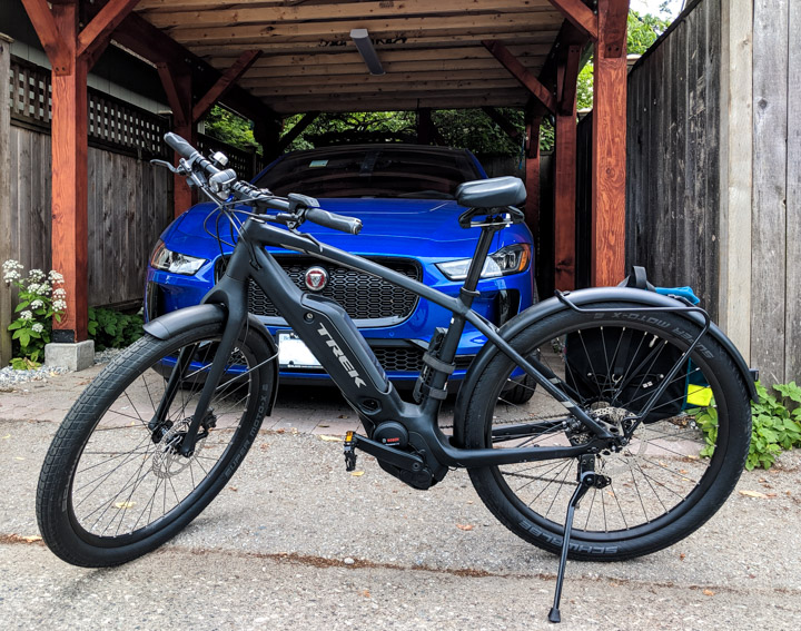 Trek Commuter+ 7 e-bike and Jaguar I-Pace electric car