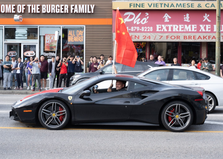Pro-Beijing demonstrators in a Ferrari