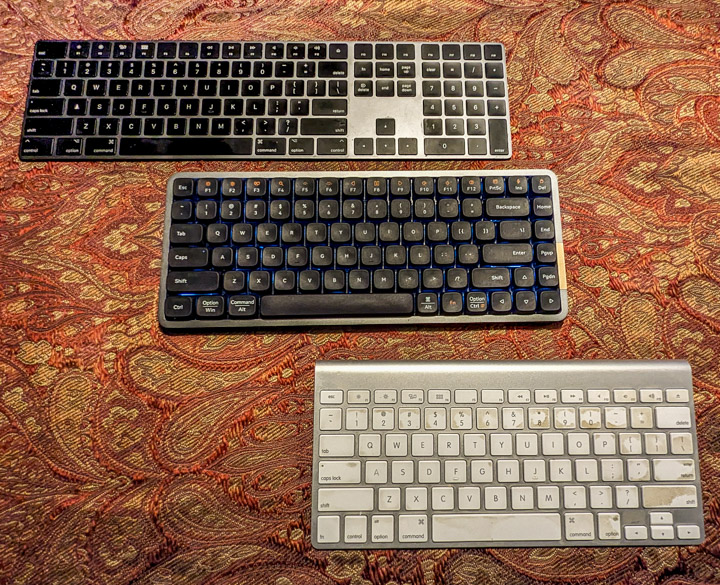 Three wireless keyboards, two from Apple one from Lofree Three wireless keyboards, two from Apple one from Lofree