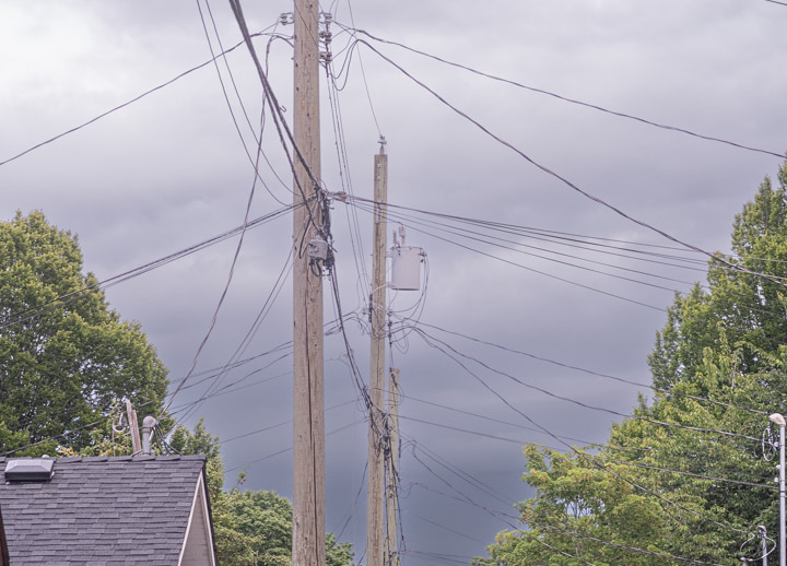 Many electrical and data wires festoon a back alley