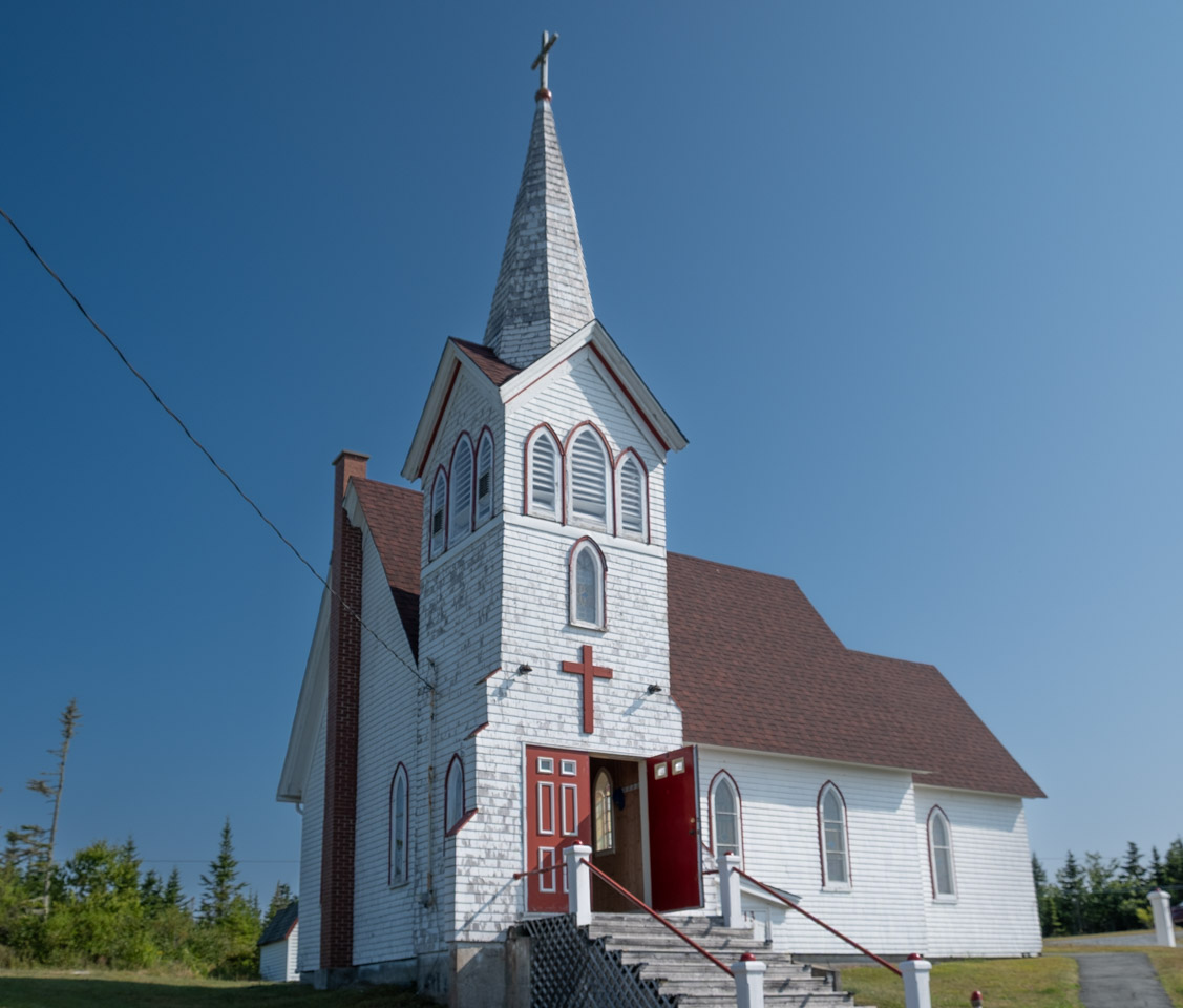 Square white wooden church, it needs a paint job