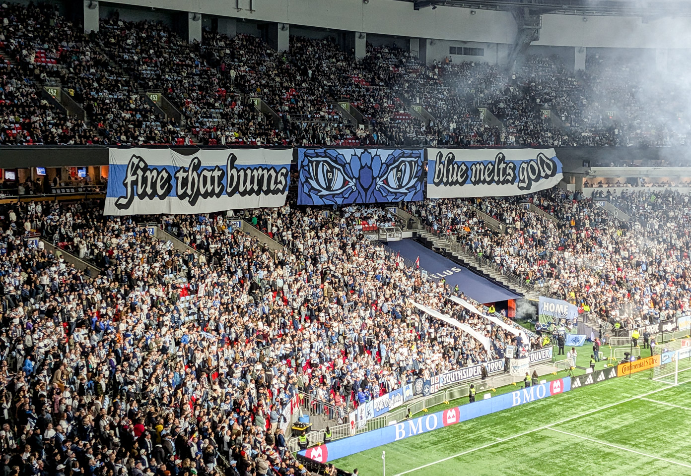 Whitecaps tifo banner: fire that burns / blue melts gold