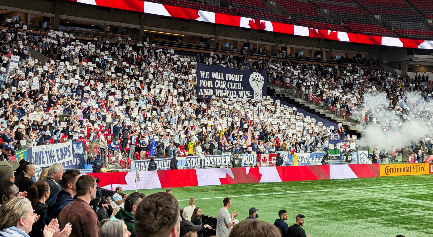 Fans with a “Save the Caps” message