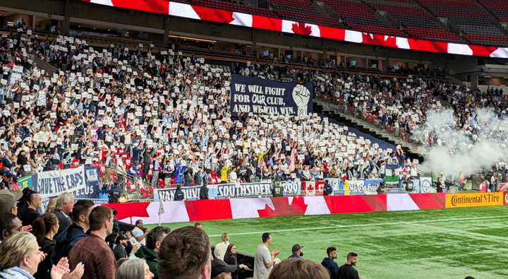 Fans with a “Save the Caps” message