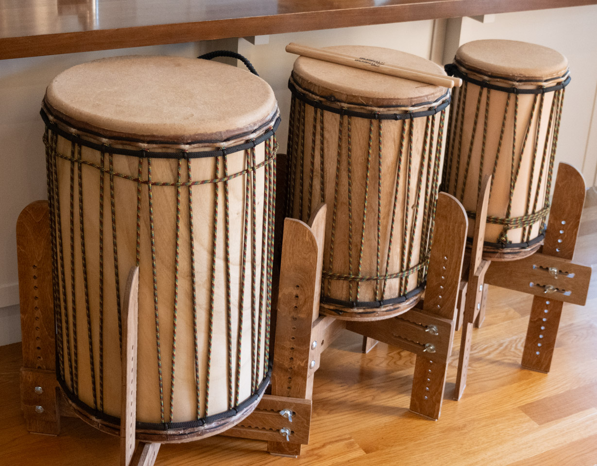 Three dununs on ballet-style stands by a kitchen island