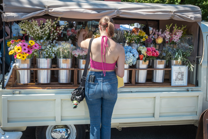 Woman shopping at a flower truck