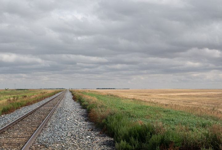 Prairie train-tracks with clouds above